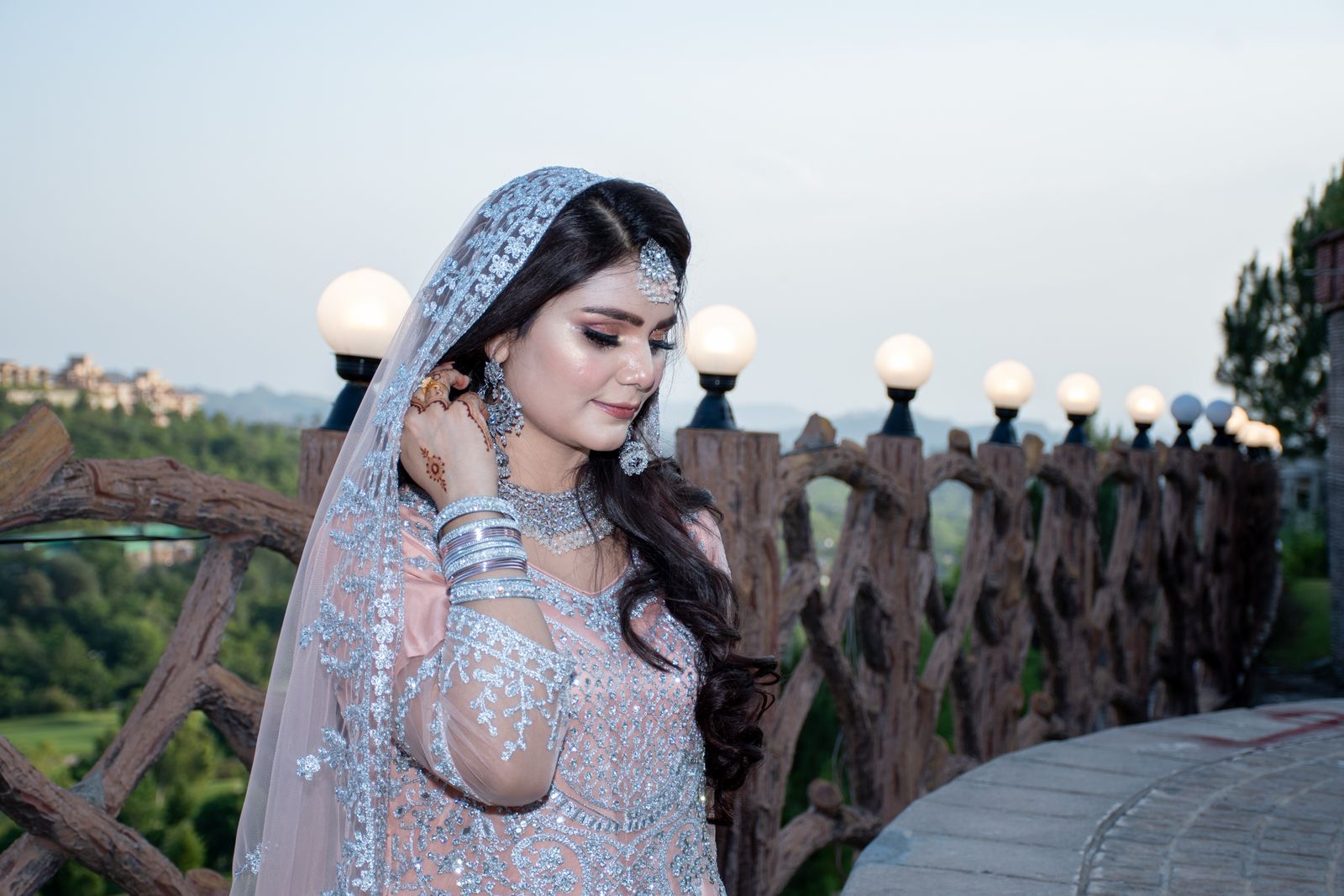 Bride in traditional Pakistani bridal wear with full bridal makeup, dupatta and jewellery