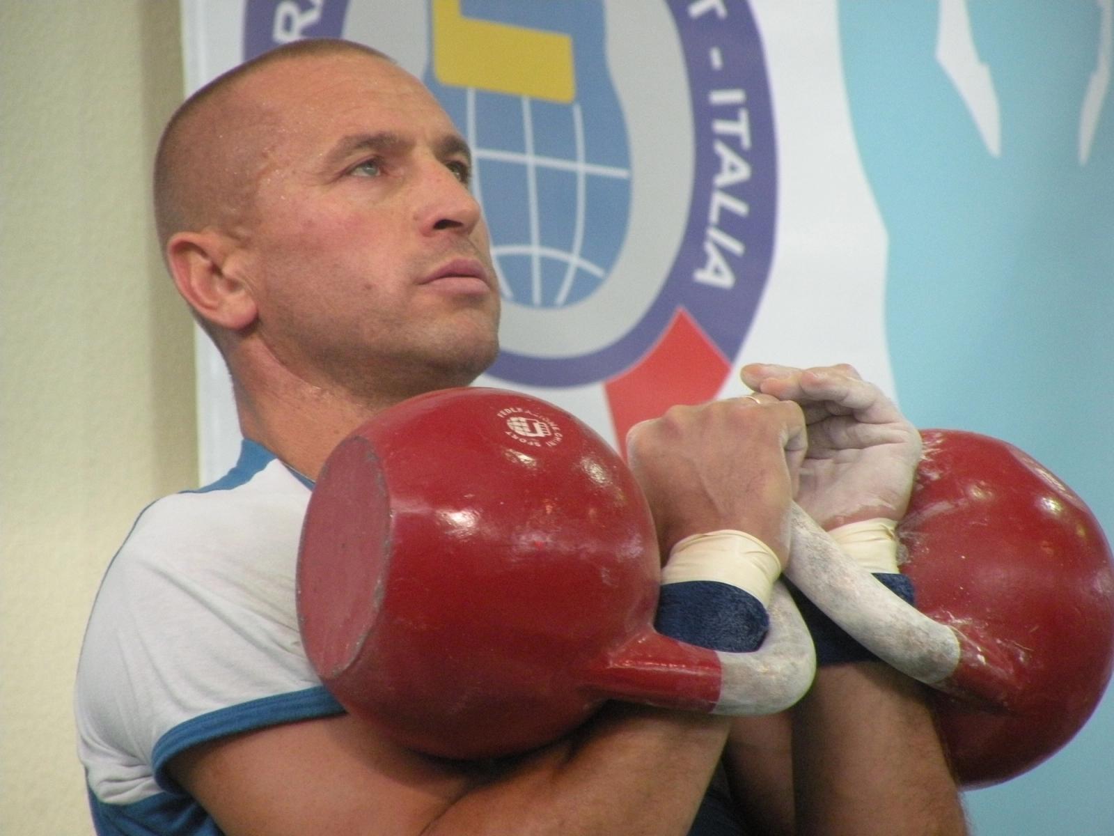 Black cast iron kettlebell on a workout floor for strength and bootcamp training
