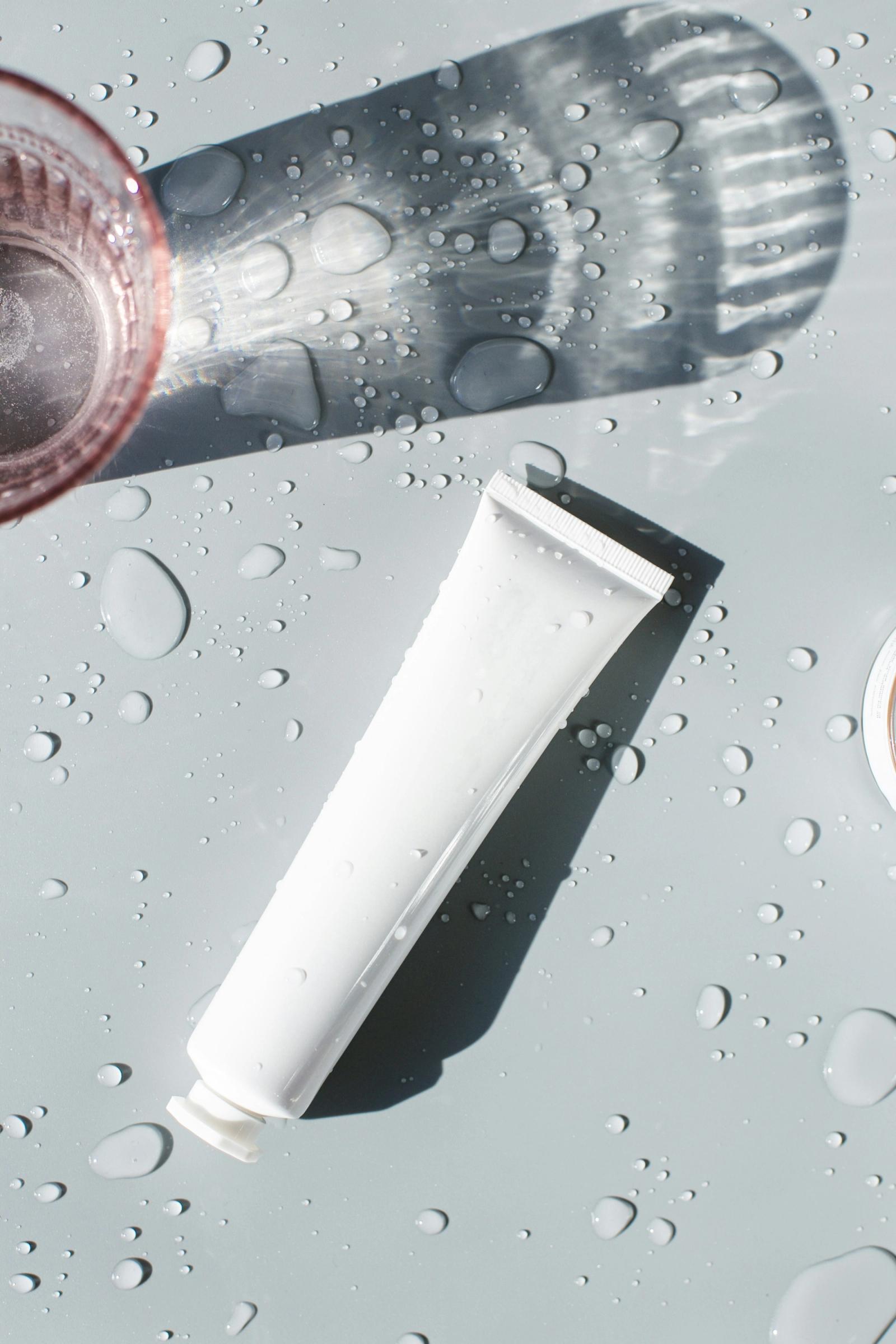 Clean aesthetic skincare tube on transparent surface