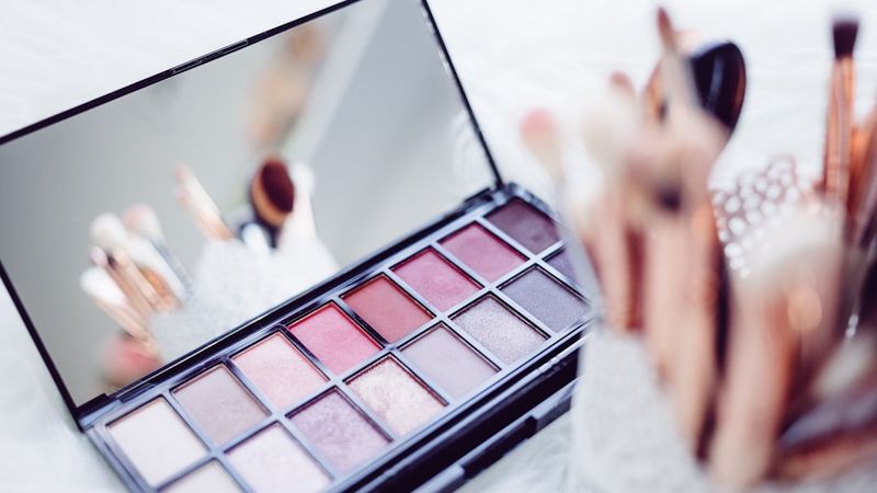 Professional eyeshadow palette and cosmetic tools in a beauty studio