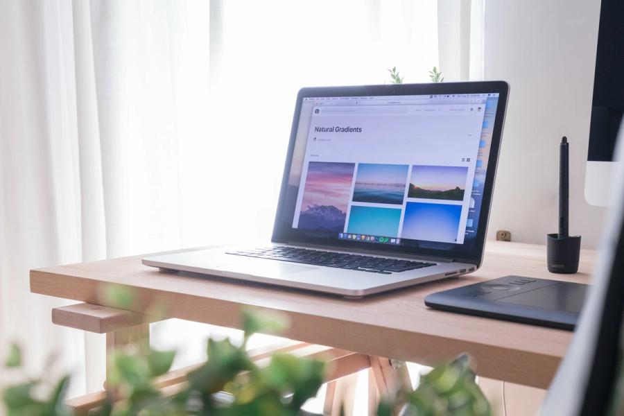 Laptop displaying a website design workspace on a desk