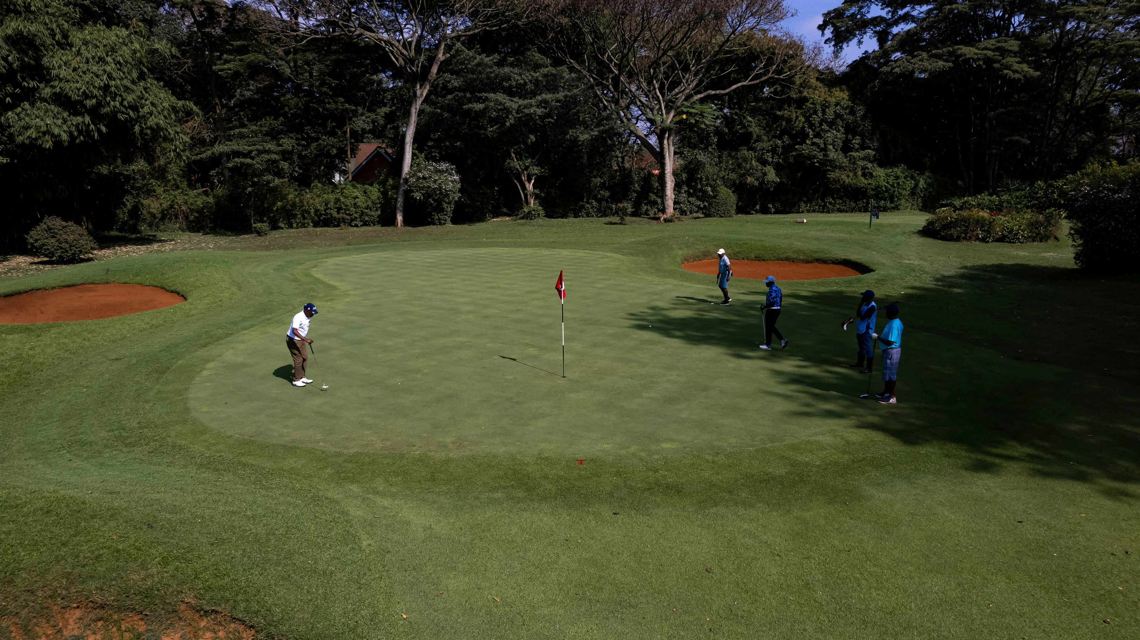 A group of people playing a game of golf