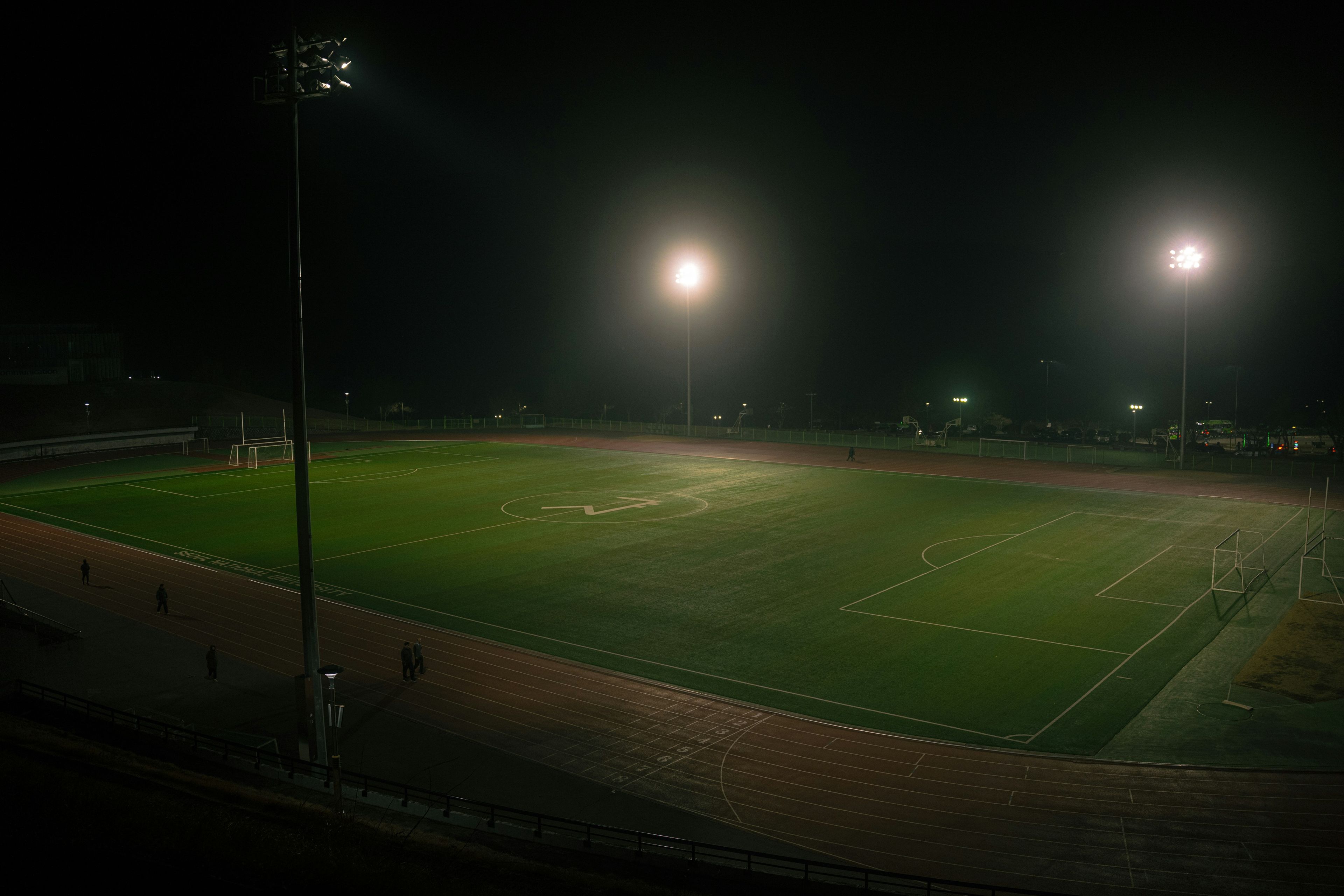 A soccer field is lit up at night