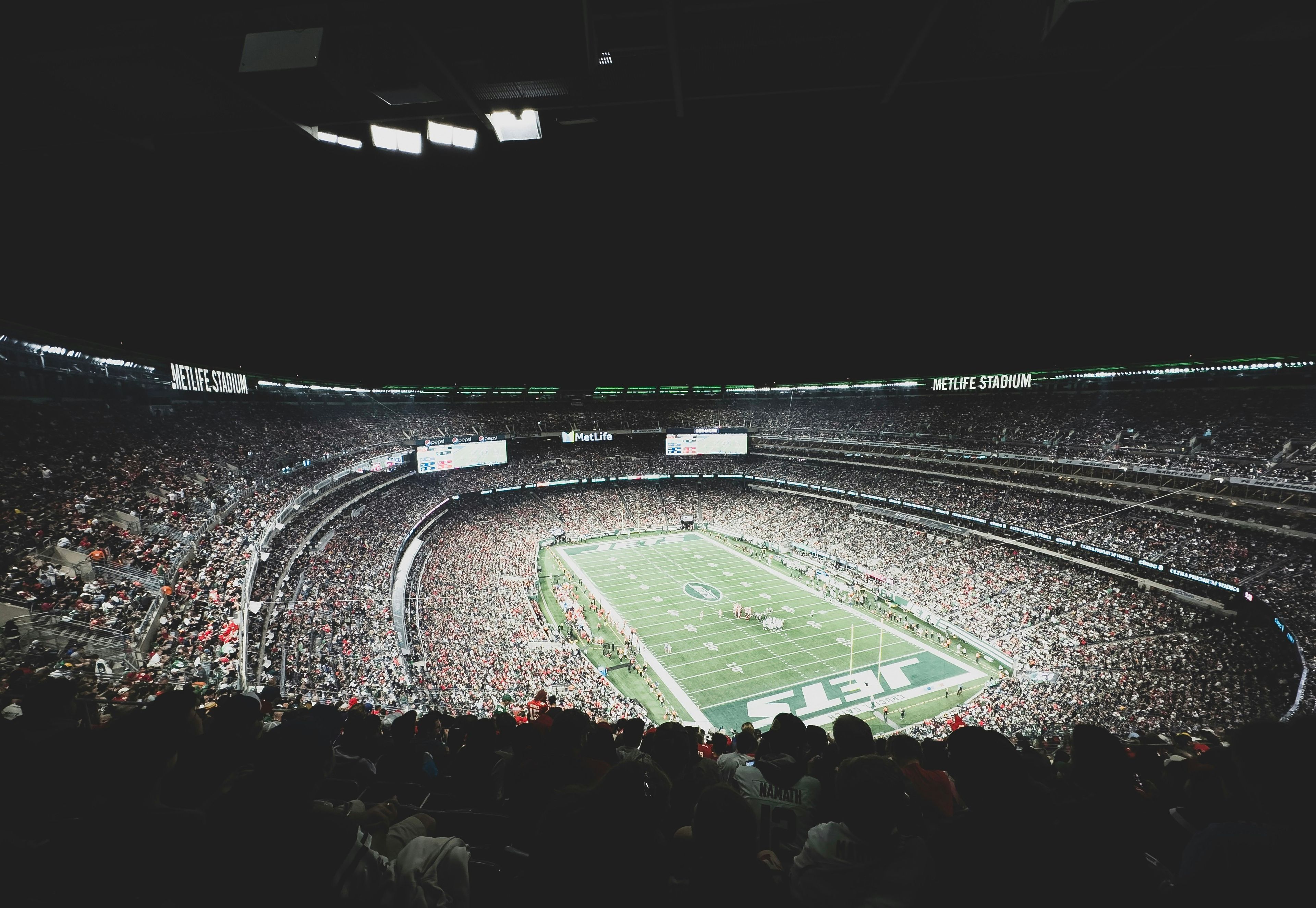 a stadium filled with lots of people watching a football game