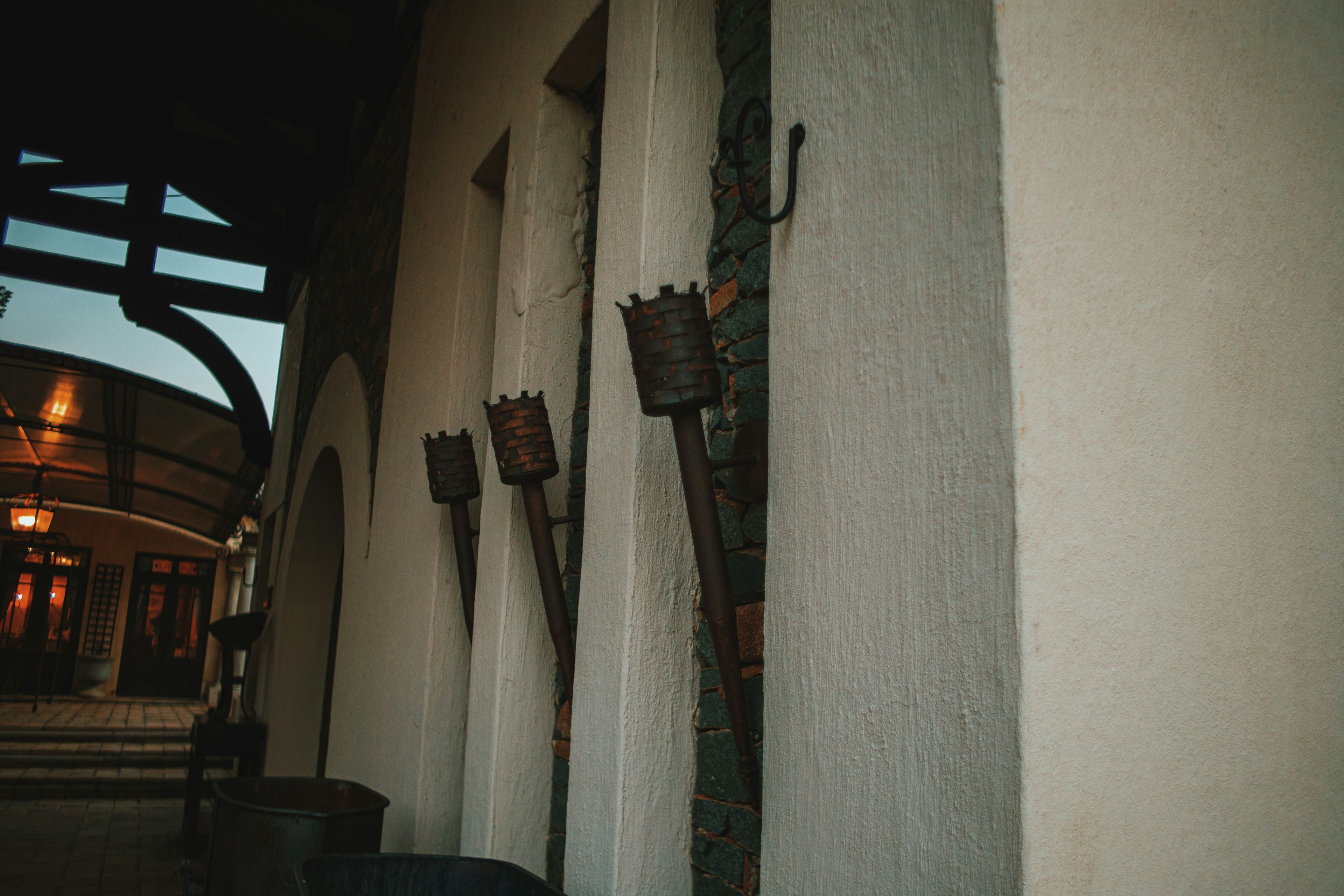 a row of metal hooks on the side of a building