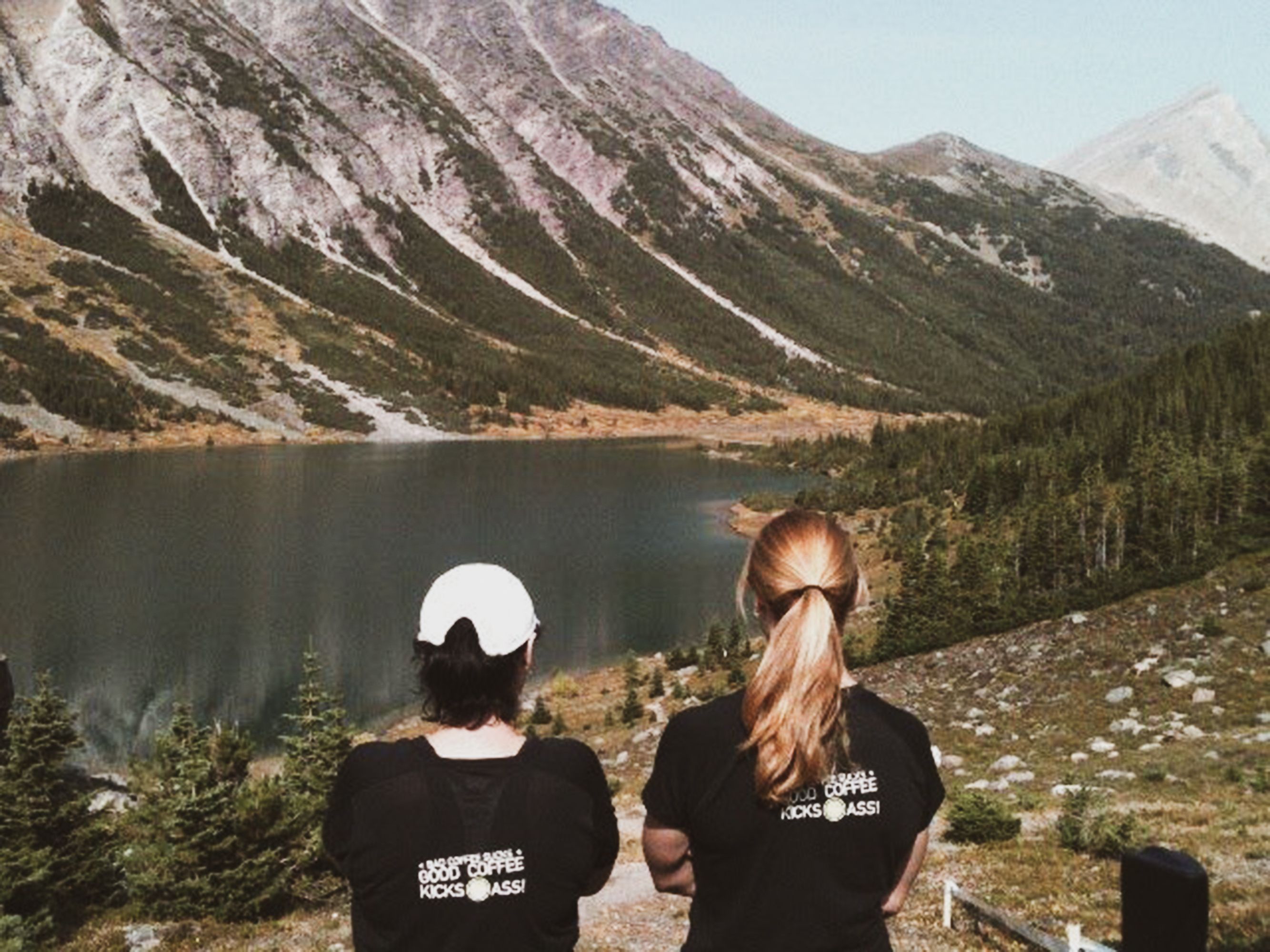 Two Kicking Horse Coffee Employees Overlooking Lake and Mountains 
