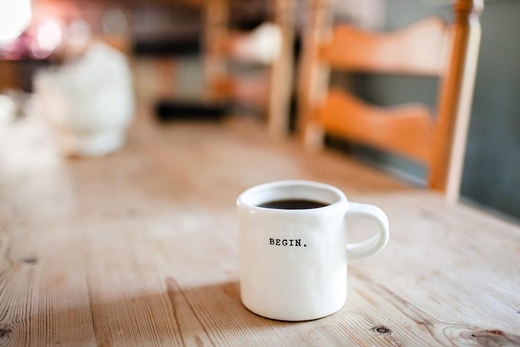 coffee in mug that says "begin"