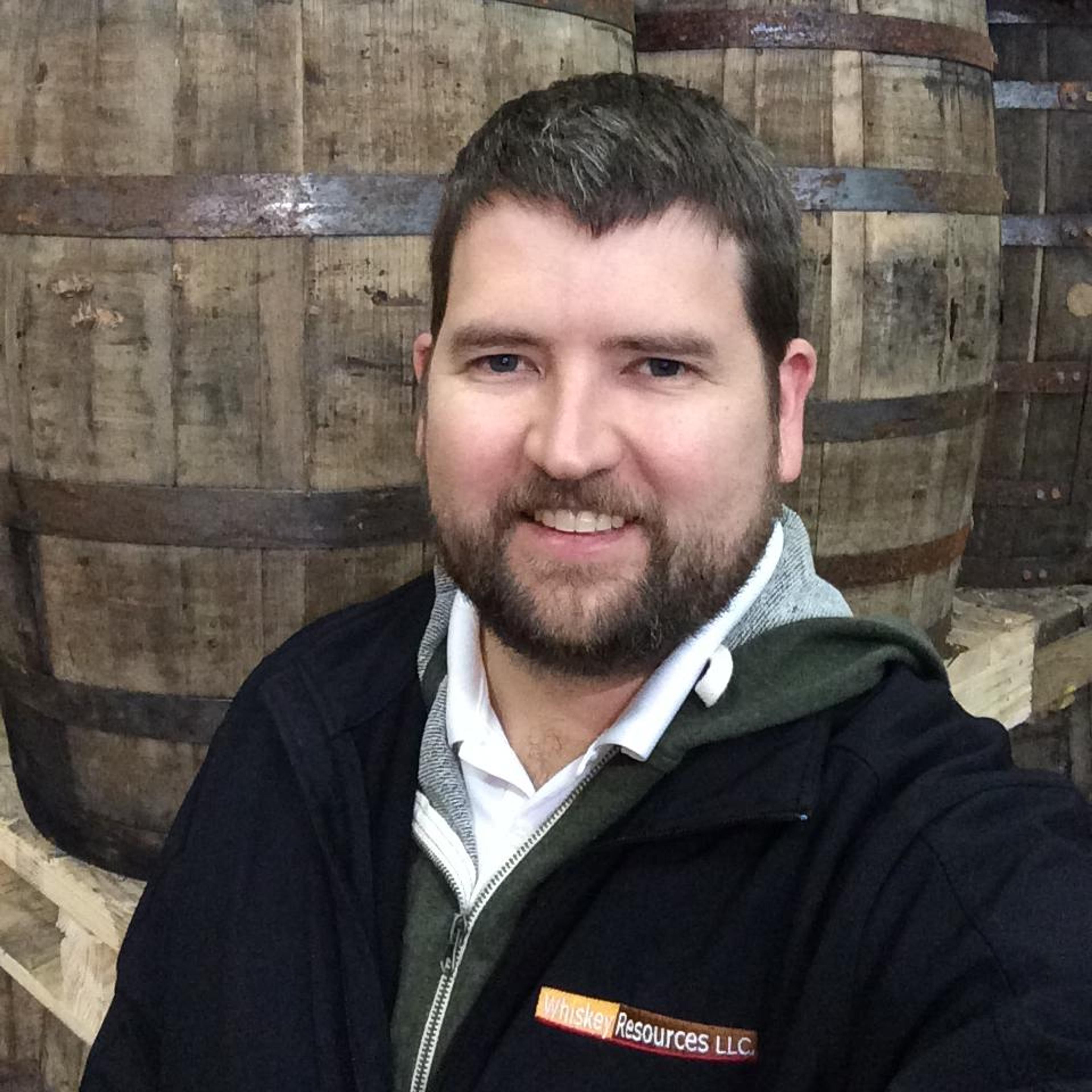 Donald Snyder in front of barrels