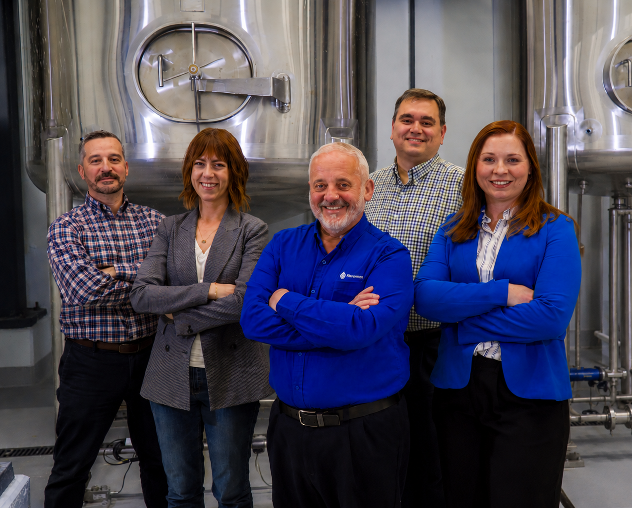Flavorman employees posing in front of tanks