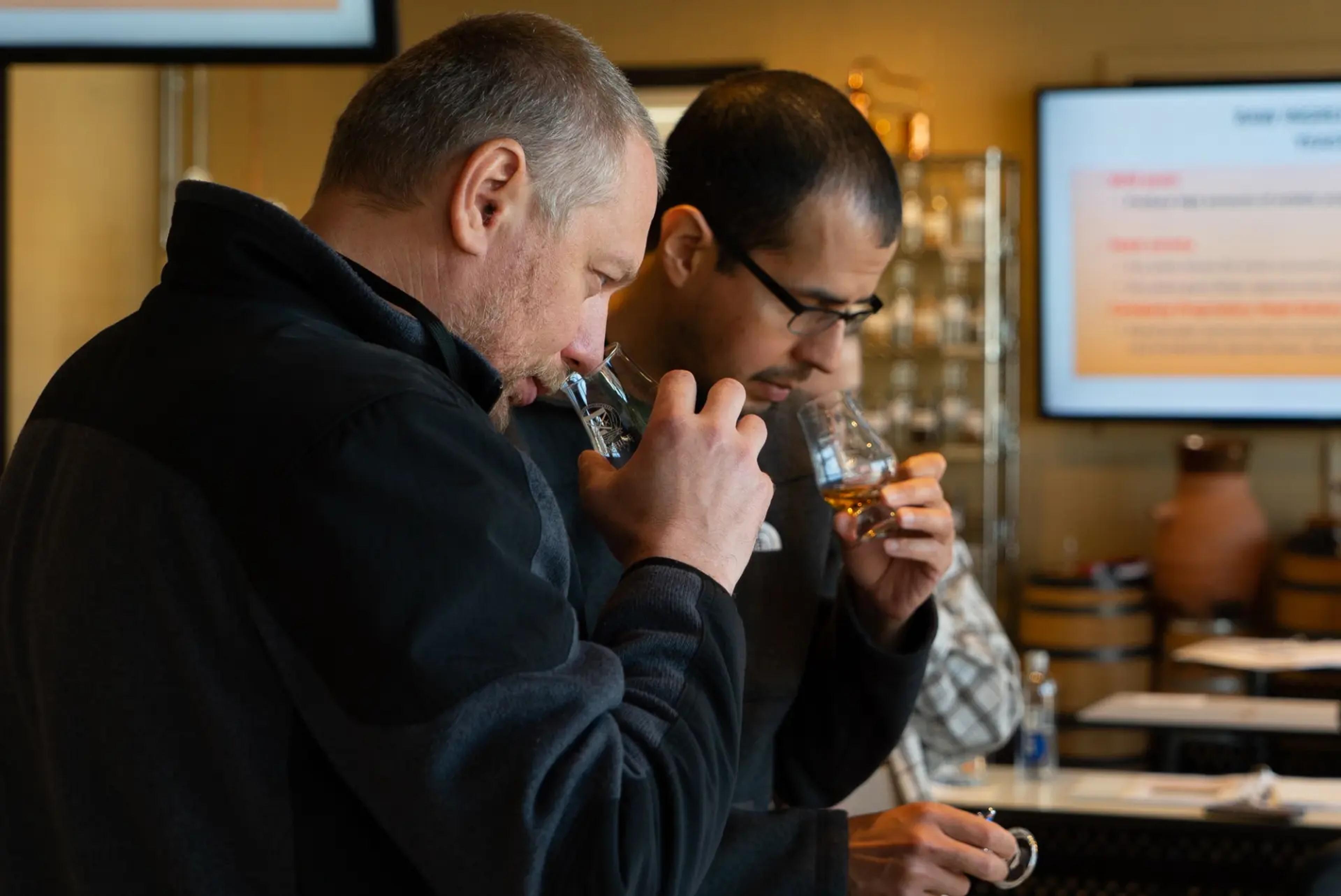 Two Moonshine University attendees nosing spirits