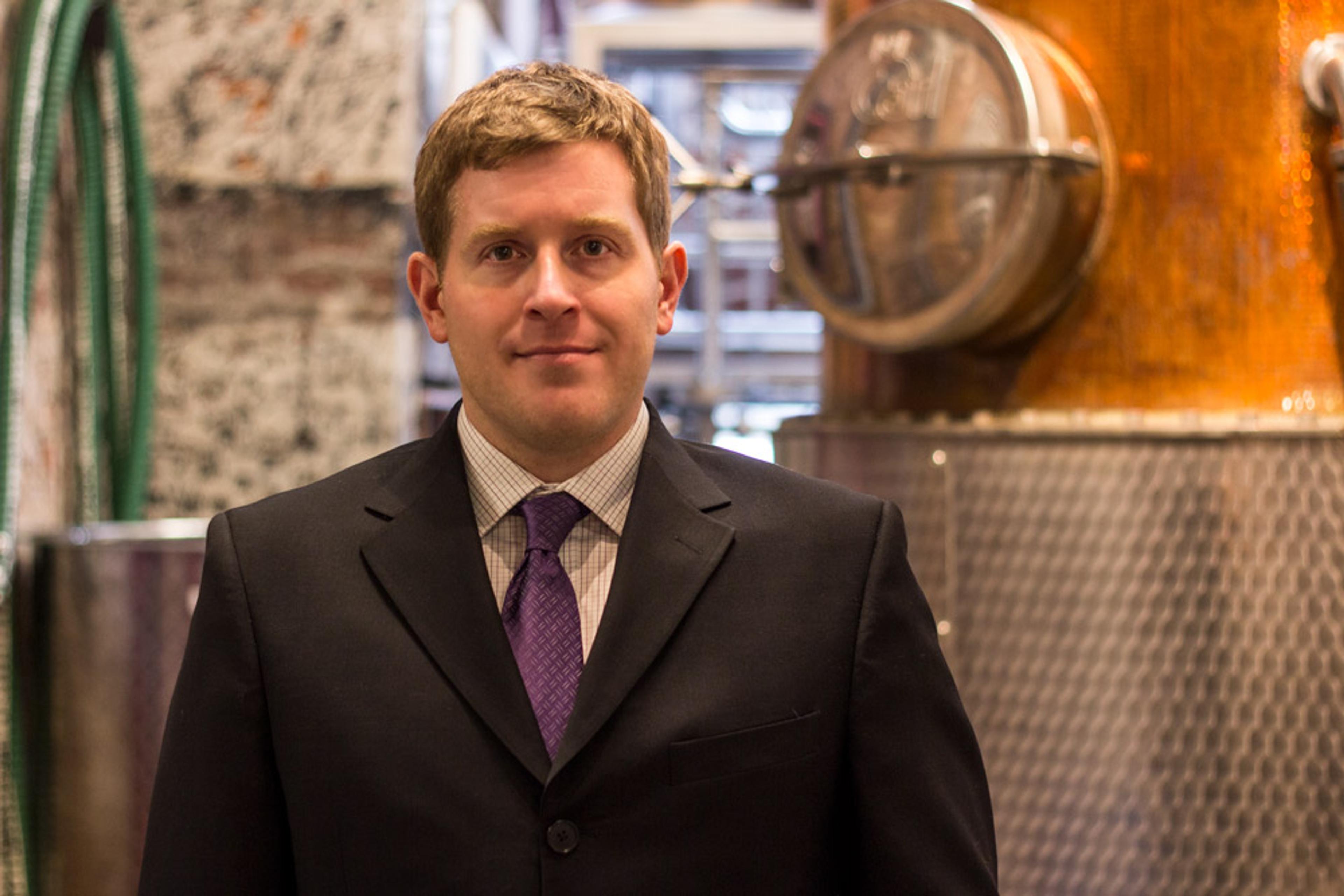 John Messinger in front of still