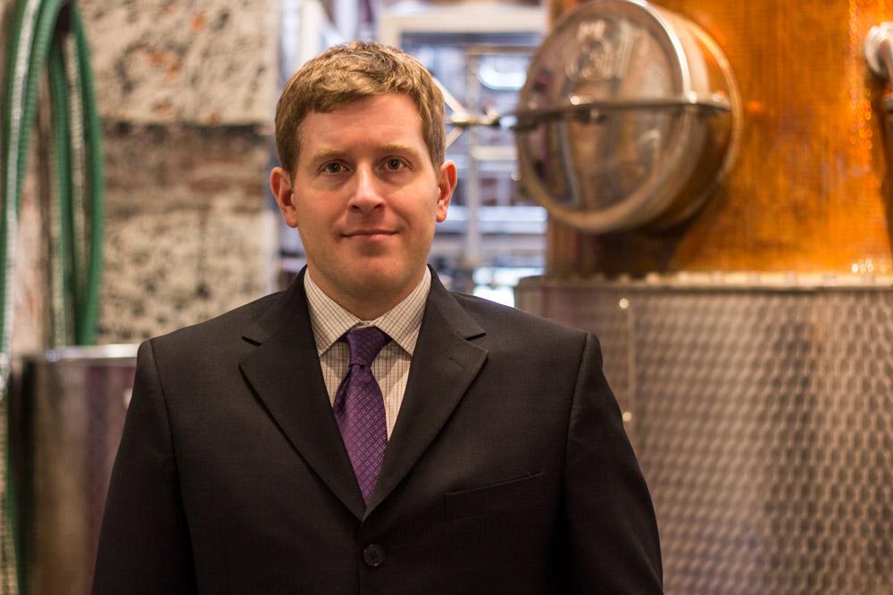 John Messinger in front of still