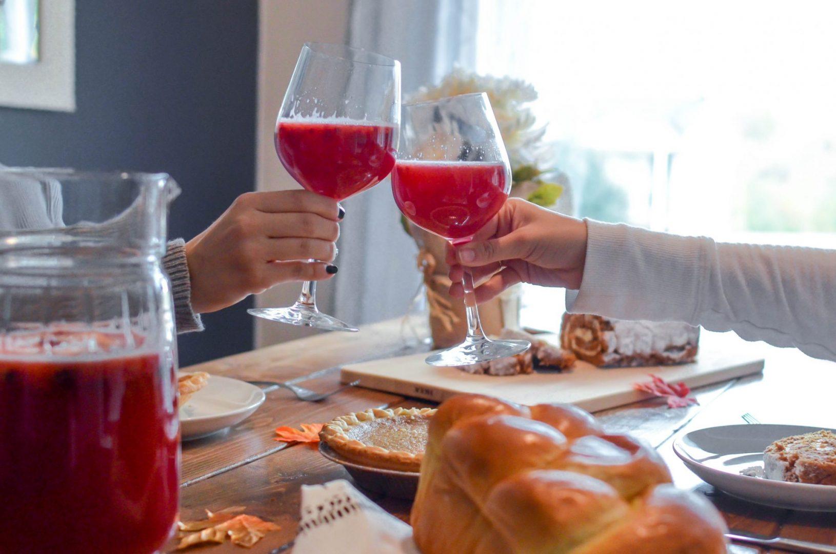 clinking glasses of sangria over thanksgiving table