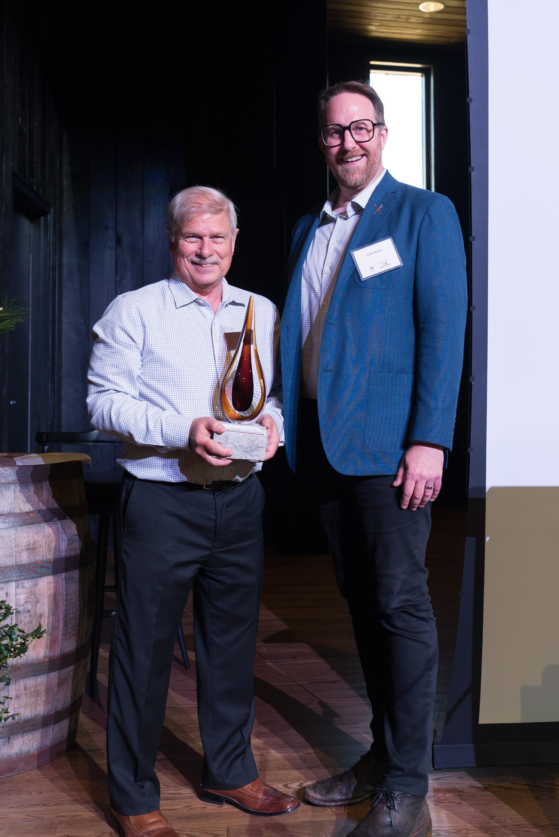 Pete Kamer and Colin Blake posing with award