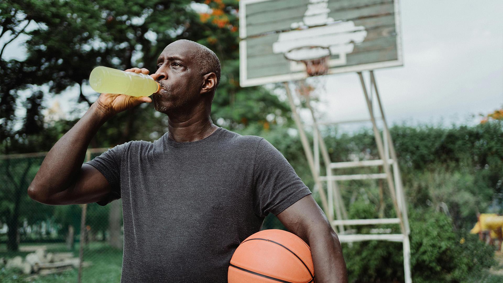 basketball player drinking hydration beverage 