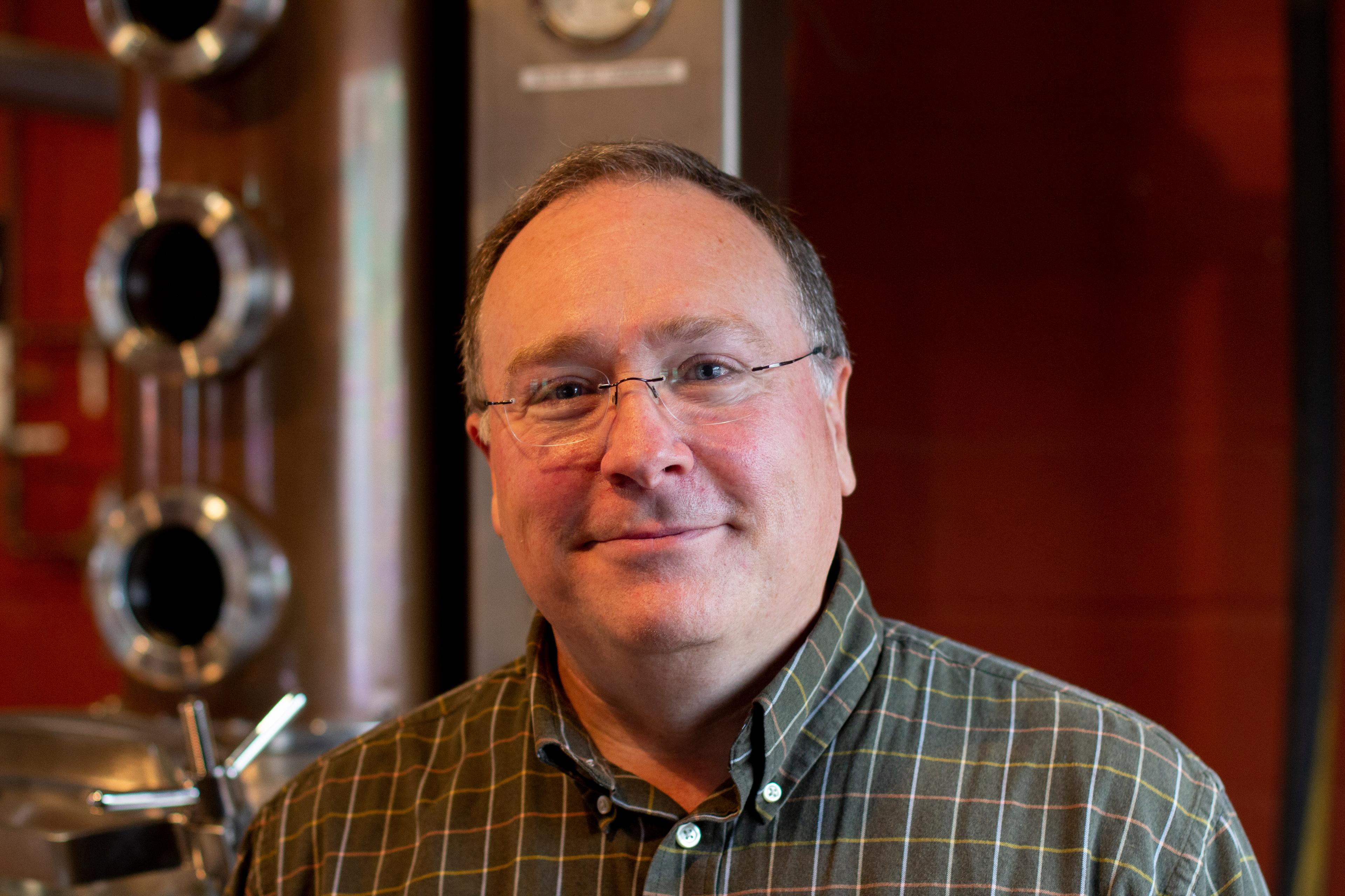 Larry Coomes in front of a still