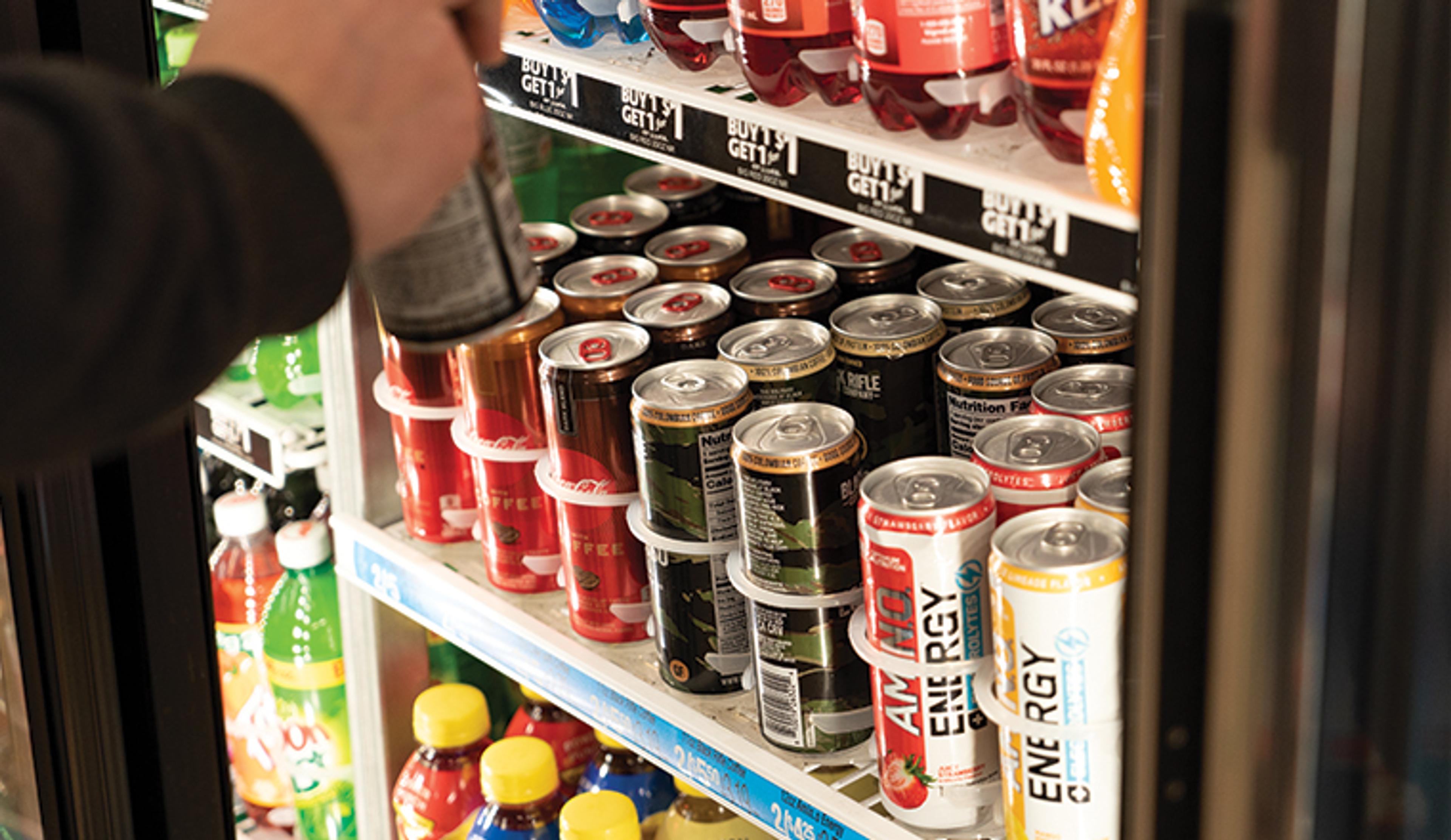 lineup of energy drinks in fridge 