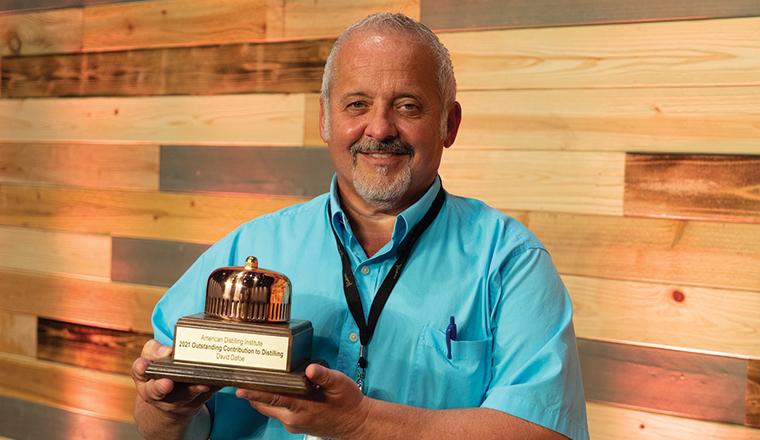 Flavorman founder David Dafoe holding the outstanding contribution to distilling award given by the American Distilling Institute.
