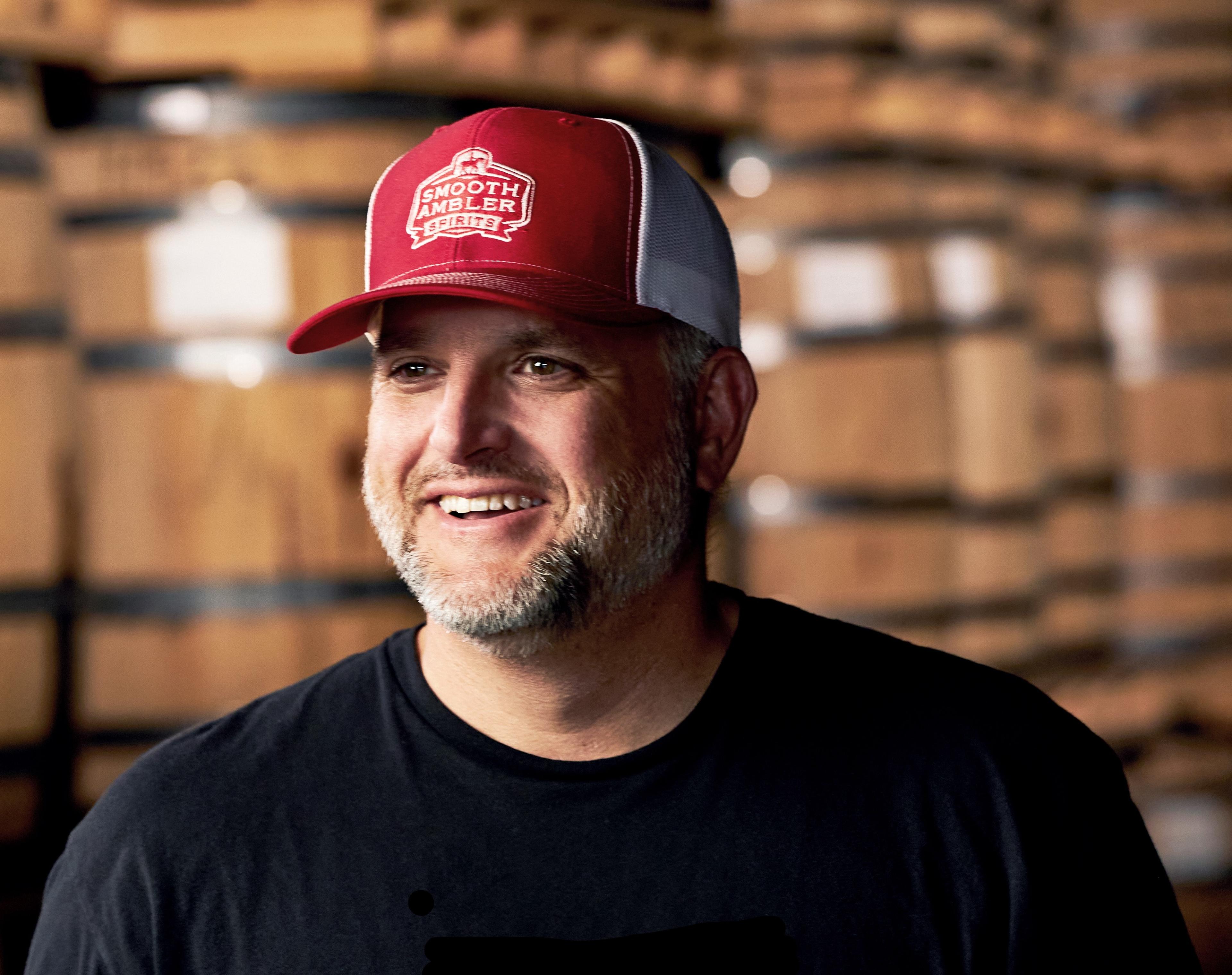 John Little in front of barrels