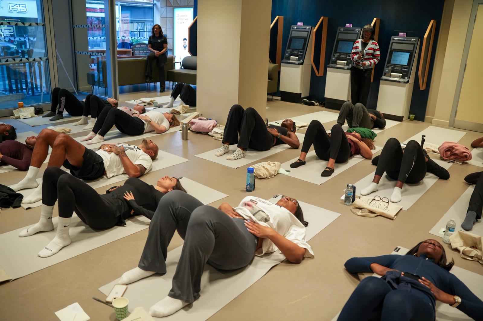 Participants taking part in a Pilates session at Heaven’s Touch Therapy’s Come As You Are wellbeing event at Barclays High Street Kensington.
