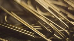 a close up of gold paper clips