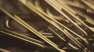 a close up of gold paper clips