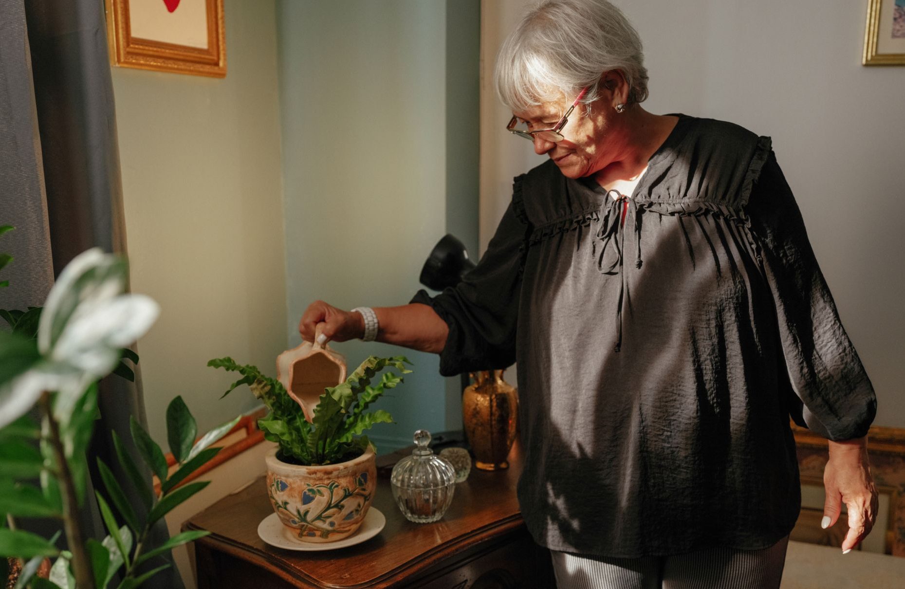 Candid photo of Tania Guimaraes, LCSW, watering a plant