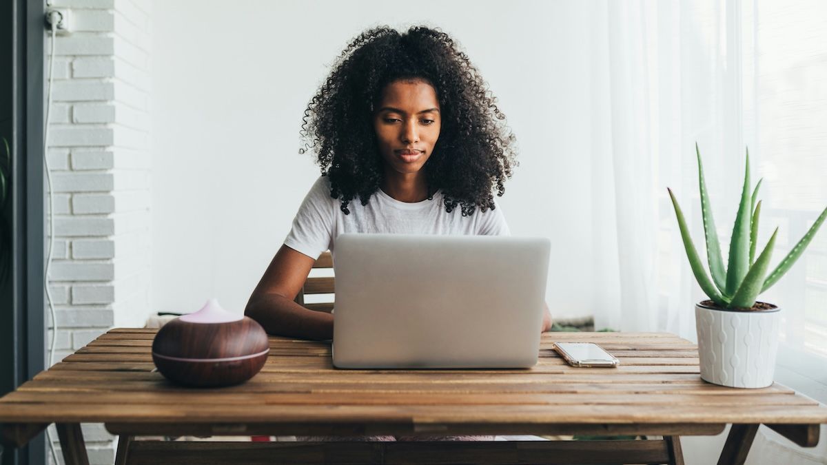 A woman on her laptop, learning about employee assistance programs