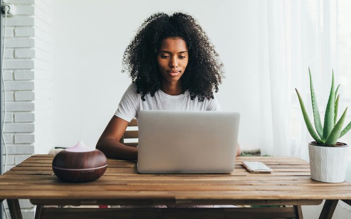A woman on her laptop, learning about employee assistance programs