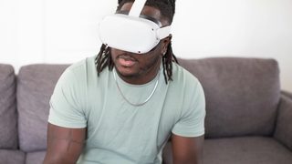 A client sits on a therapist's couch undergoing a virtual reality treatment session for PTSD