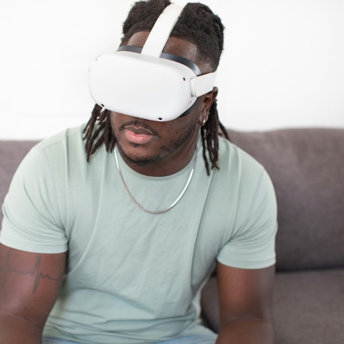 A client sits on a therapist's couch undergoing a virtual reality treatment session for PTSD