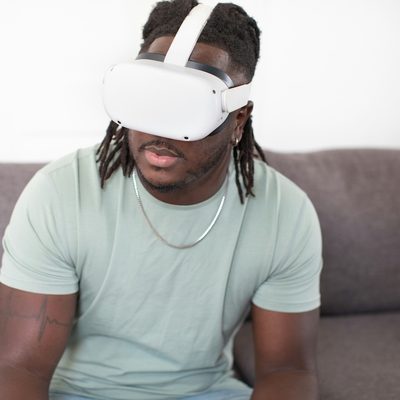 A client sits on a therapist's couch undergoing a virtual reality treatment session for PTSD