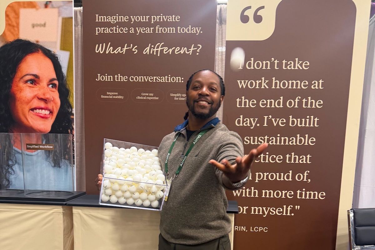 An Alma staffer tossing a ping pong in the air at the 2026 ACA Conference in Columbus, OH