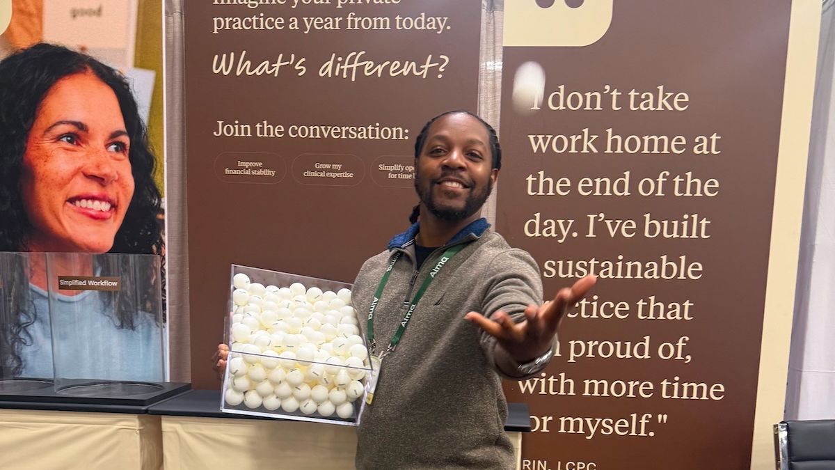 An Alma staffer tossing a ping pong in the air at the 2026 ACA Conference in Columbus, OH