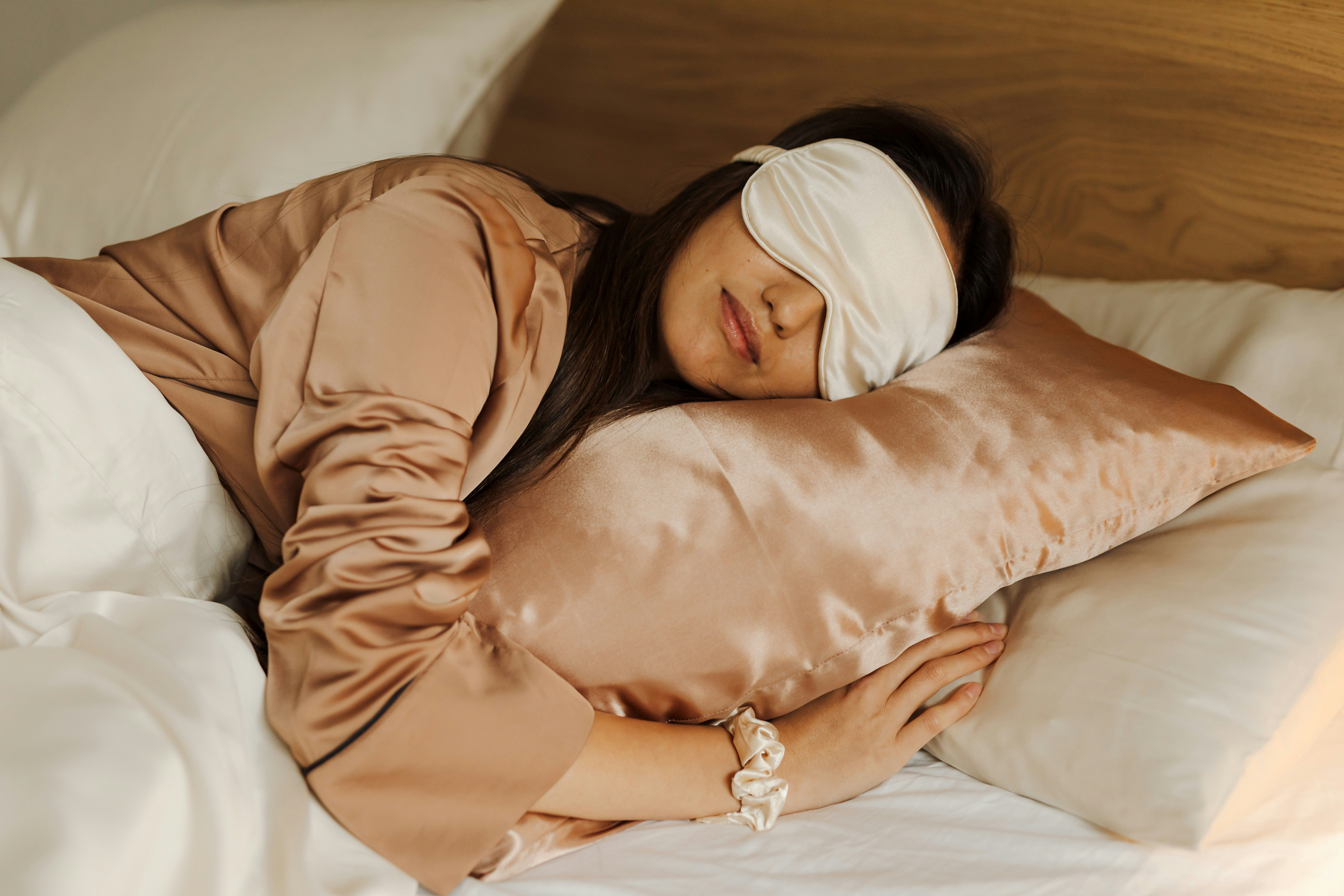 Woman sleeping in bed with an eye mask on