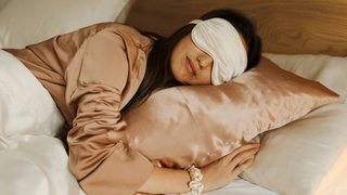 Woman sleeping in bed with an eye mask on