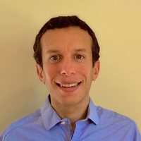 An image of Jonathan Wolff, a doctoral student in a blue oxford shirt with short brown hair.