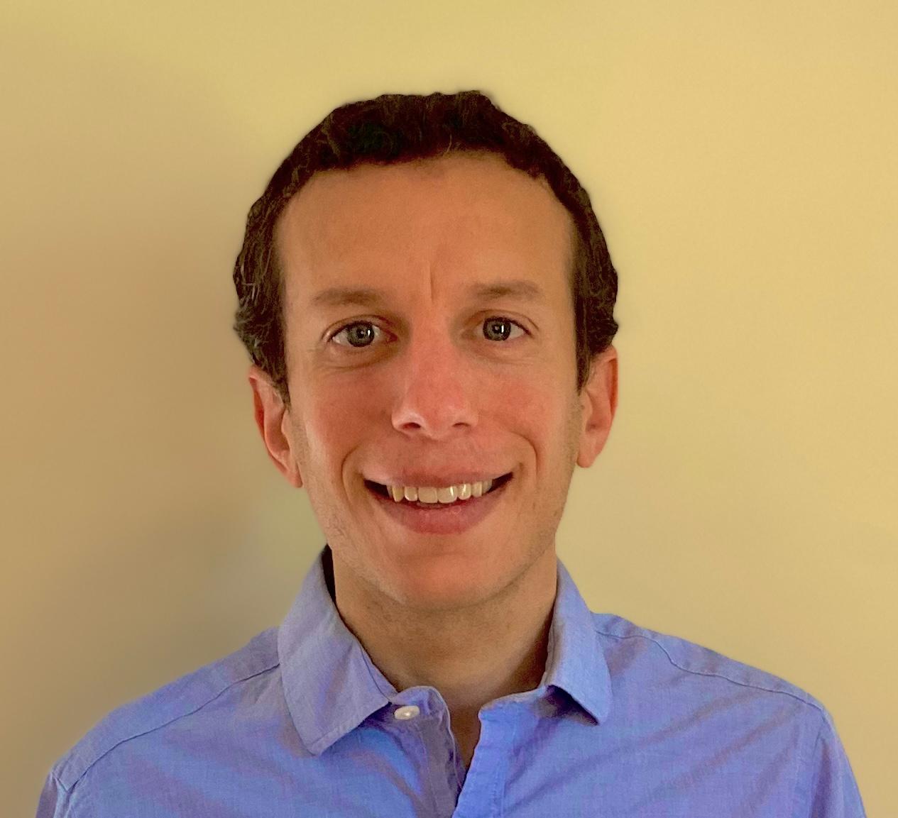An image of Jonathan Wolff, a doctoral student in a blue oxford shirt with short brown hair.