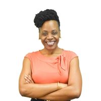 A picture of Antoinette Bryce, arms crossed, against a white backdrop.