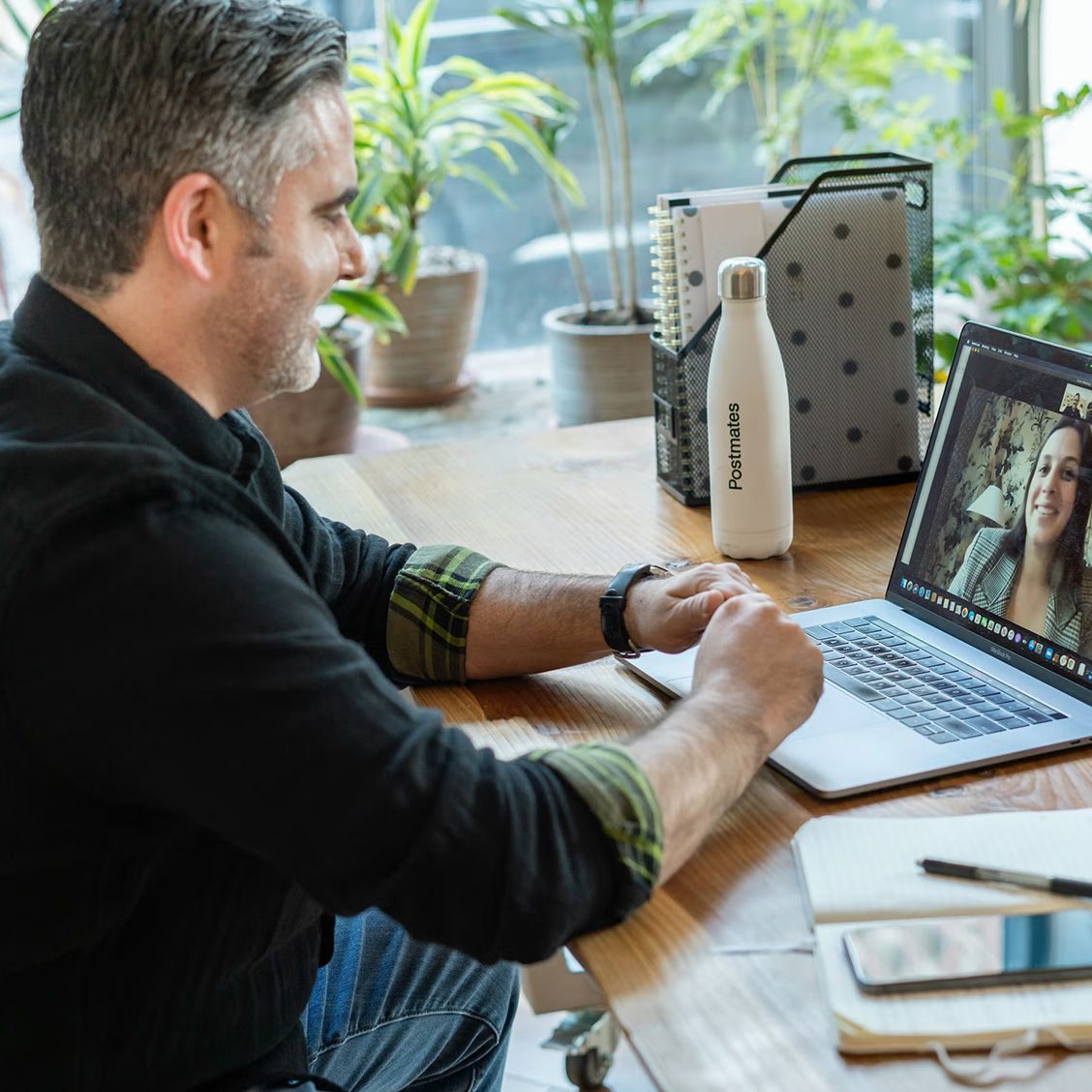 A person sitting at their desk talking with a therapist via teletherapy