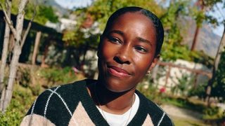 Amani Chambliss, LMFT, is shown outside in the sun, looking optimistic and determined