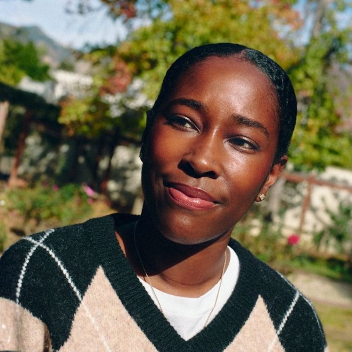 Amani Chambliss, LMFT, is shown outside in the sun, looking optimistic and determined