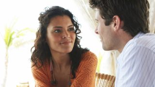A couple with different attachment styles talk on a sunny afternoon