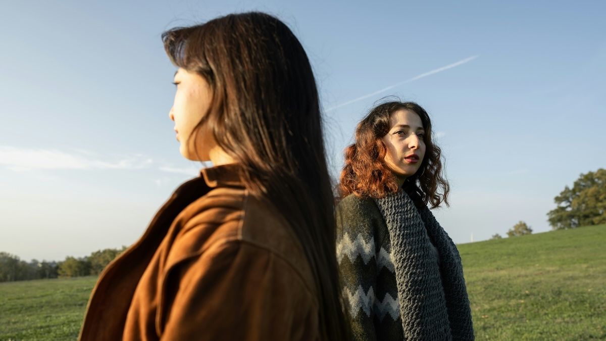 two women looking away from each other after their friendship has ended