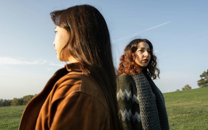two women looking away from each other after their friendship has ended