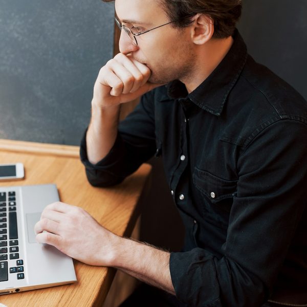 a male therapist is at his desk, working on amending documentation