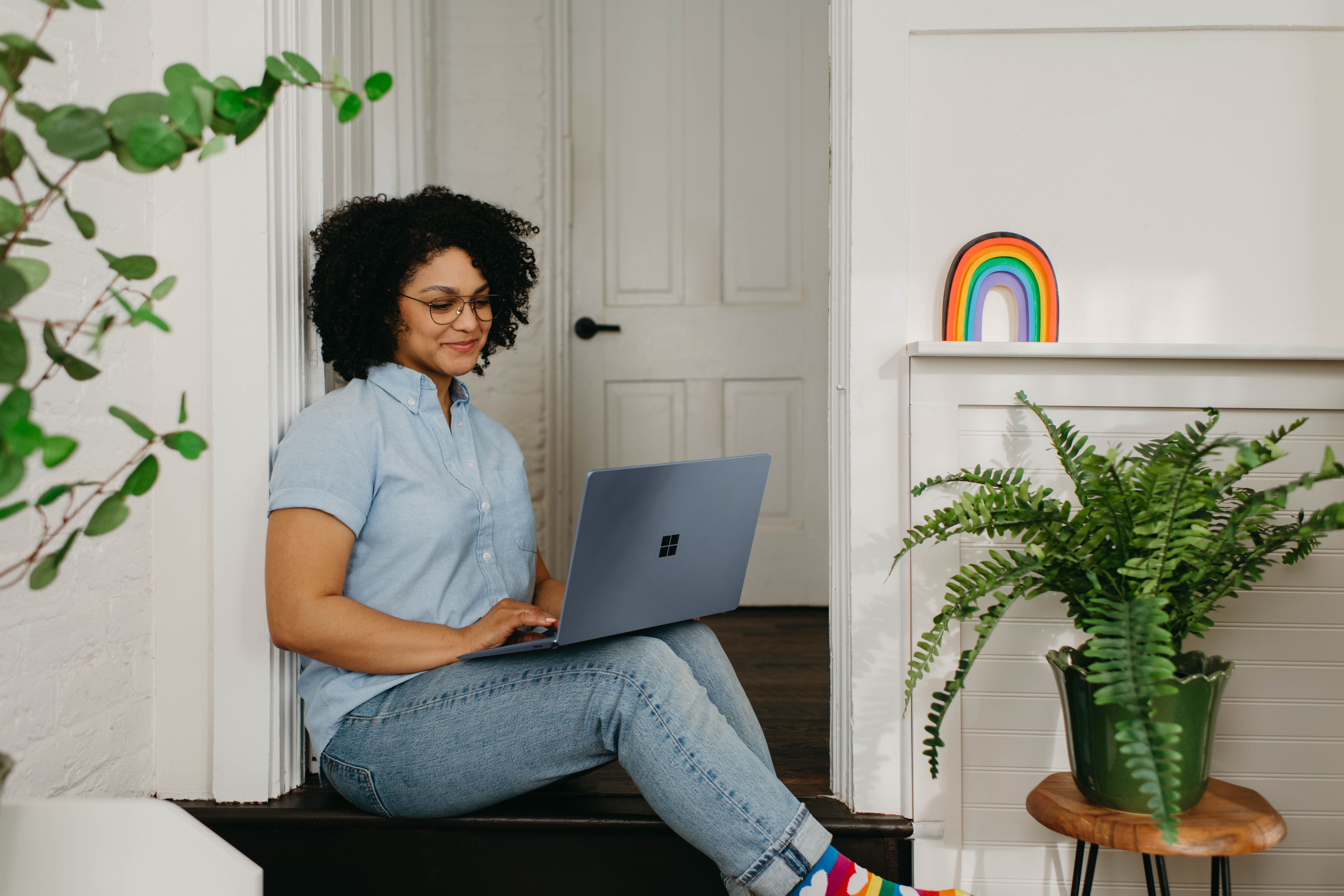 woman sitting on the floor with her laptop opened on her lap 