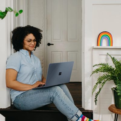 woman sitting on the floor with her laptop opened on her lap