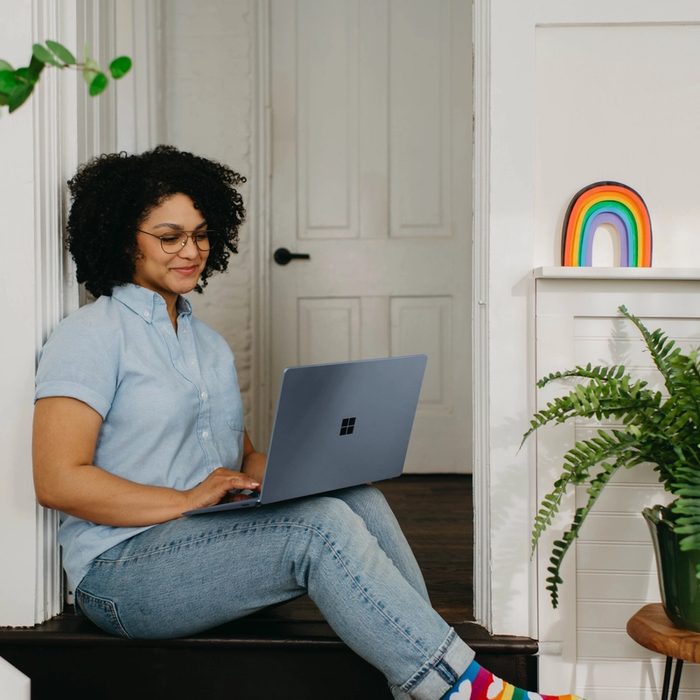 woman sitting on the floor with her laptop opened on her lap