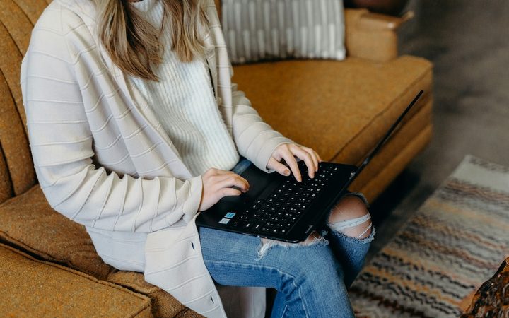 A woman on her laptop, learning about her Aetna EAP